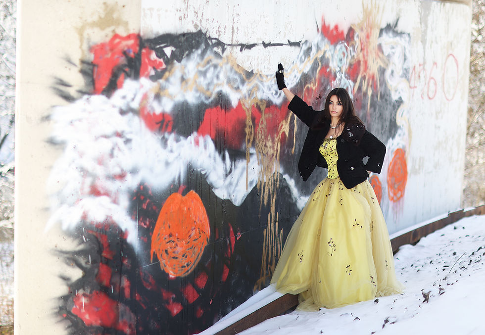 Hannah Politte viewing modern art in Southeast Missouri wearing yellow dress black coat