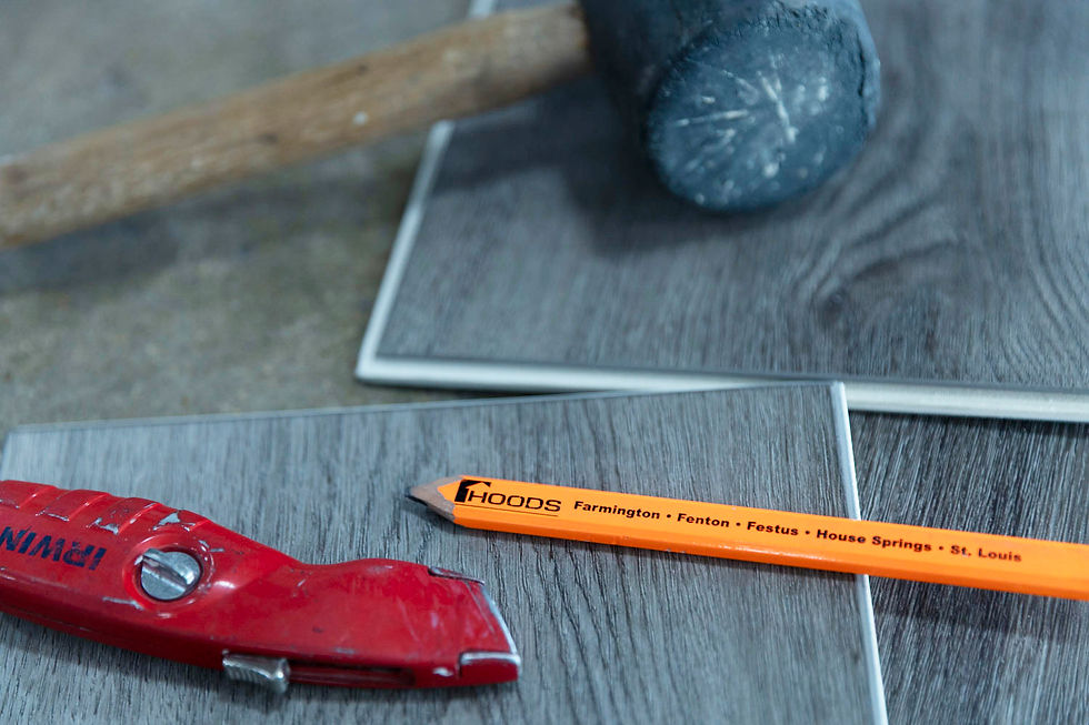    "Basic tools for DIY flooring installation including tape measure, box cutter, and rubber mallet on the new waterproof planks. #DIYWaterproofFlooring #EliteFlooring"