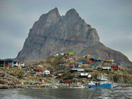heart shape mountain with multi colored houses at its base