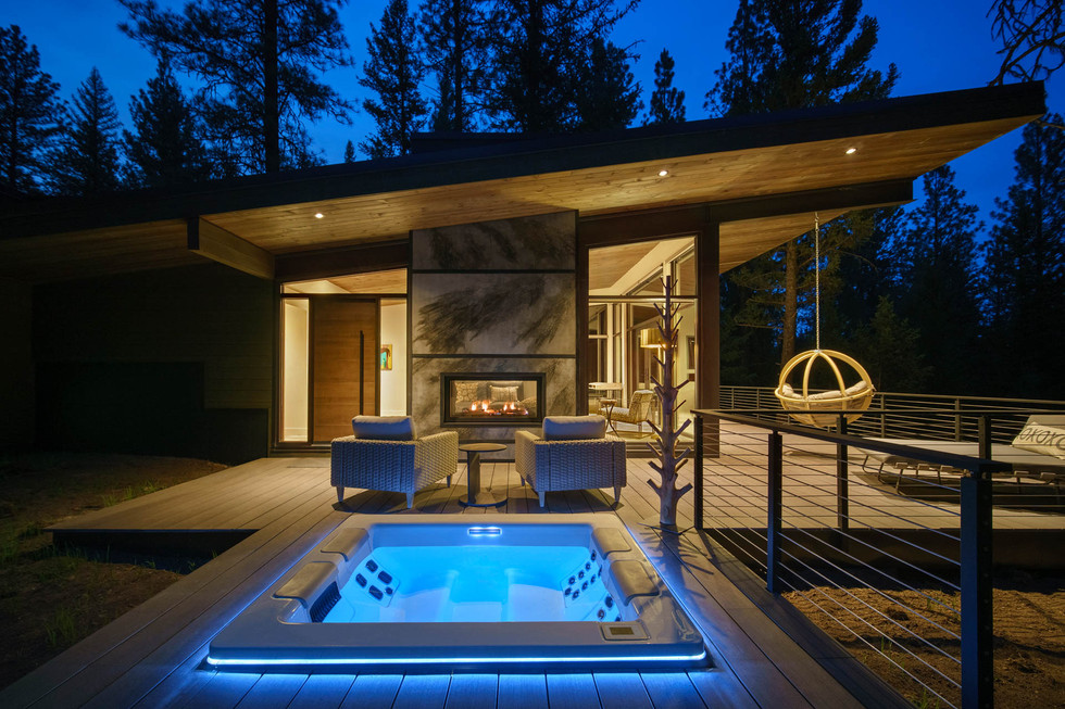modern home at night with blue hot tub lights