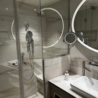 bathroom and shower with LED framed mirror