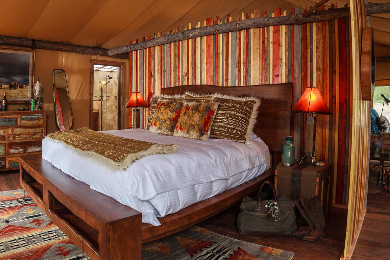 bed with white linens and western style wll decoration