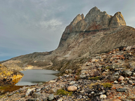 mountain with small grey lake in front