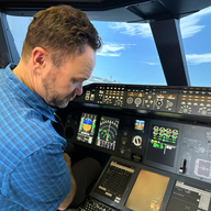 Man in blue shirt in plane cockpit