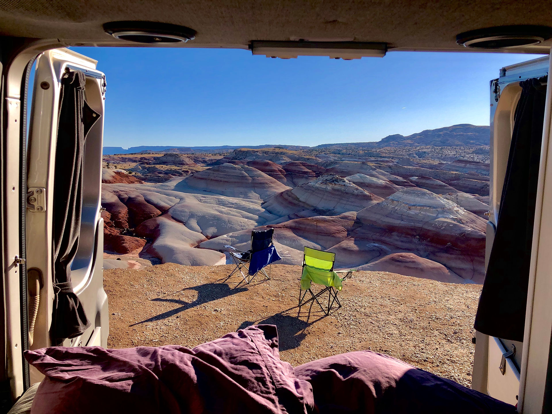 Camper van and chairs at Bentonite Hills