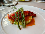 orange lobster tail and green asparagus on white plate