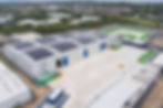 A drone shot of 2 large fully constructed warehouses side by side 