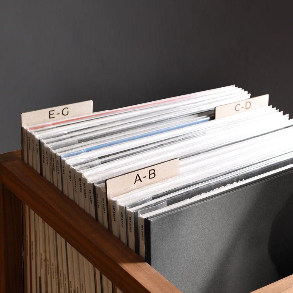 vinyl record dividers with laser-engraved custom alphabetical titles separating records inside a minimal solid walnut record