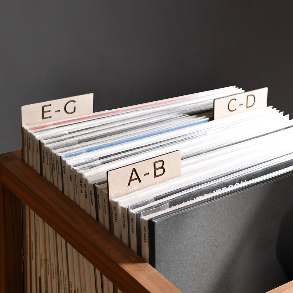 vinyl record dividers with laser-engraved custom alphabetical titles separating records inside a minimal solid walnut record