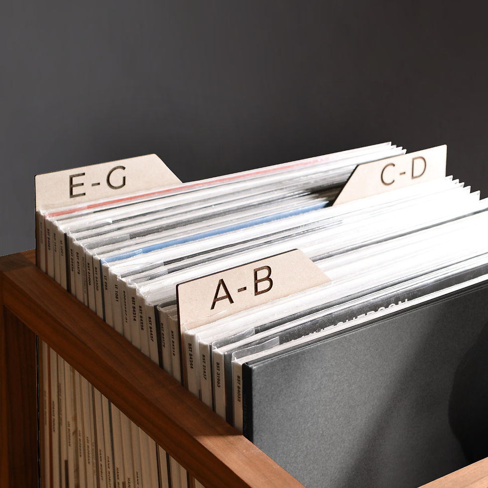 vinyl record dividers with laser-engraved custom alphabetical titles separating records inside a minimal solid walnut record