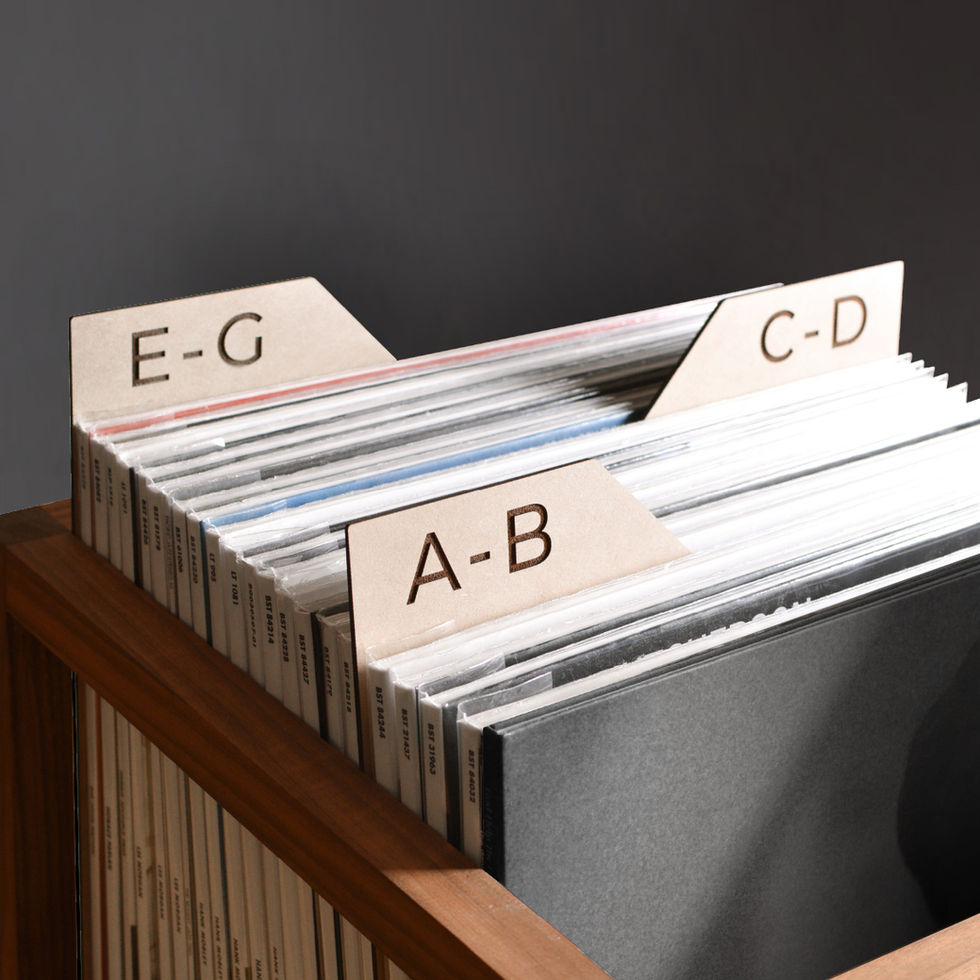vinyl record dividers with laser-engraved custom alphabetical titles separating records inside a minimal solid walnut record