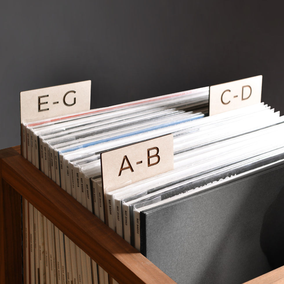 vinyl record dividers with laser-engraved custom alphabetical titles separating records inside a minimal solid walnut record