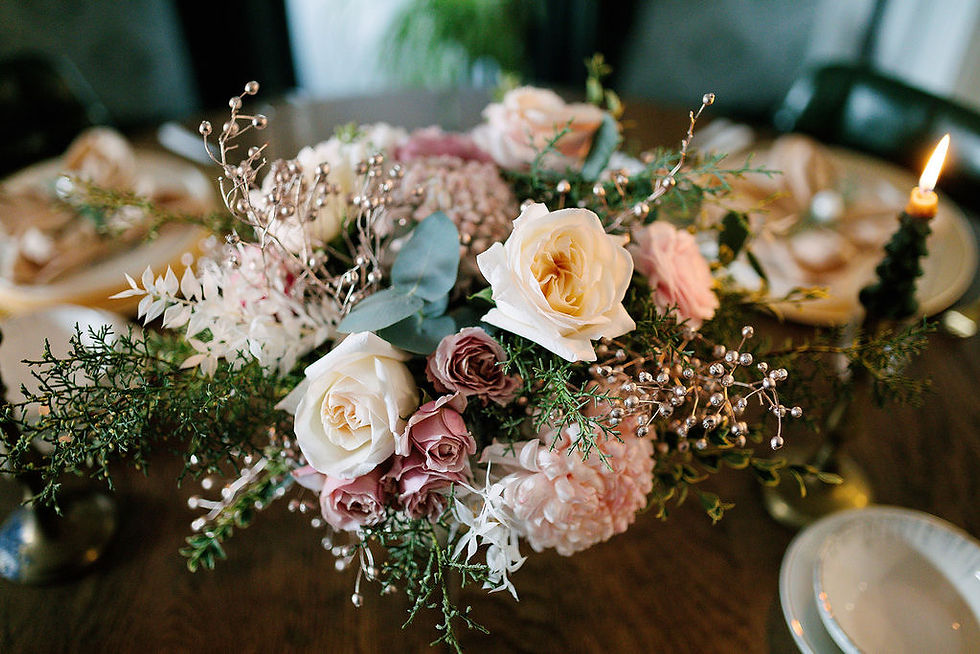 Holiday compote centerpiece with garden roses, candy-cane striped Mums, winter greens, and seasonal blooms