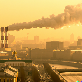 DALL·E 2023-03-04 15.41.08 - big city landscape, smoke from chimneys, streets paved with g