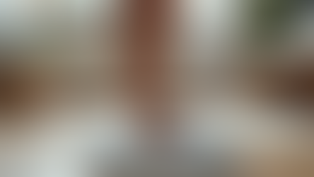 Bare feet on a digital scale in a bright room with plants, a fluffy rug, and a wooden floor, creating a calm atmosphere.