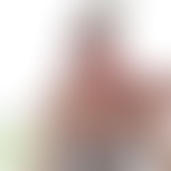 Woman in a gray tank top eating a slice of watermelon indoors, sunlight streaming through the window as she enjoys a healthy moment to stay on track with her wellness goals.