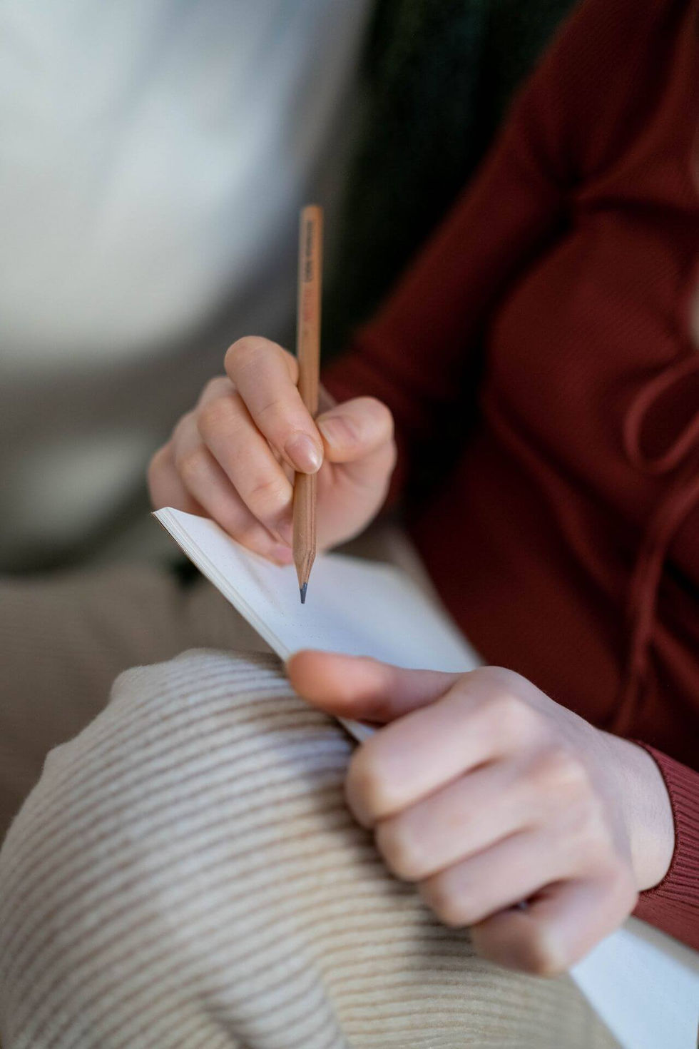 Person tracking mood, drinking patterns and emotional triggers in a notebook