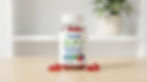 A jar of Asuno GLP-1 Weight-Loss Gummies with red gummies on a wooden table. White background with a green plant in a pot.