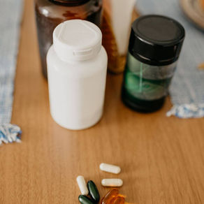 Assorted supplement bottles and capsules ready for a label-by-label comparison
