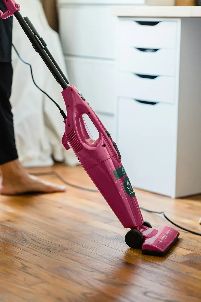 House cleaner vacuuming living room floor