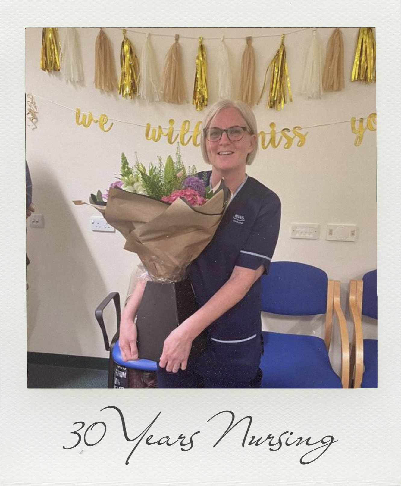 Sara wearing dark blue scrubs holding a bouquet of flowers on her last day as a nurse.