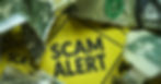 Crumbled dollar bills surround a yellow sign with bold black text reading "SCAM ALERT," conveying a warning or cautionary mood.