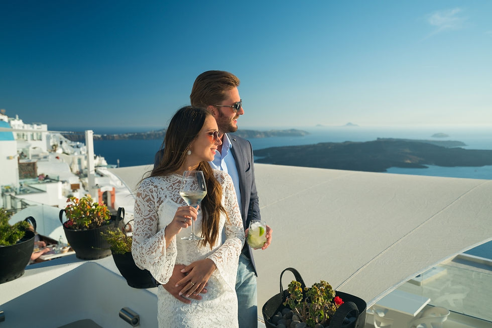 A couple drinking wine on terrace in Santorini, Greece