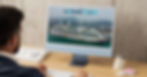 Man at desk views a computer showing a colorful cruise ship and city skyline. Screen displays "Gateway Travel" text. Calm, professional setting.