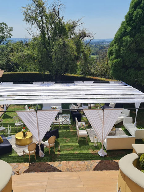 Outdoor event setup with tent, tables, and Nomalanga Events Creations decor services.