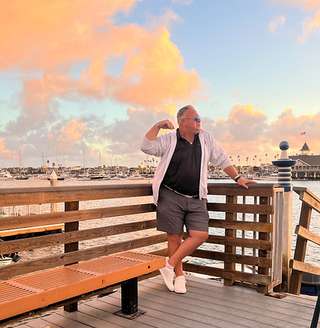 Kevin Willard of OG Swing Thoughts standing in front of a sunset on the Newport, CA pier