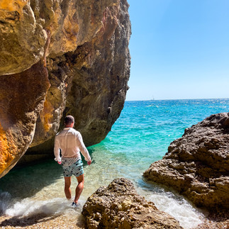 Image of Men entering Crystal clear waters of Elios-Proni beach in Kefalonia