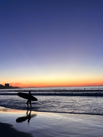 A surfer with a sunset