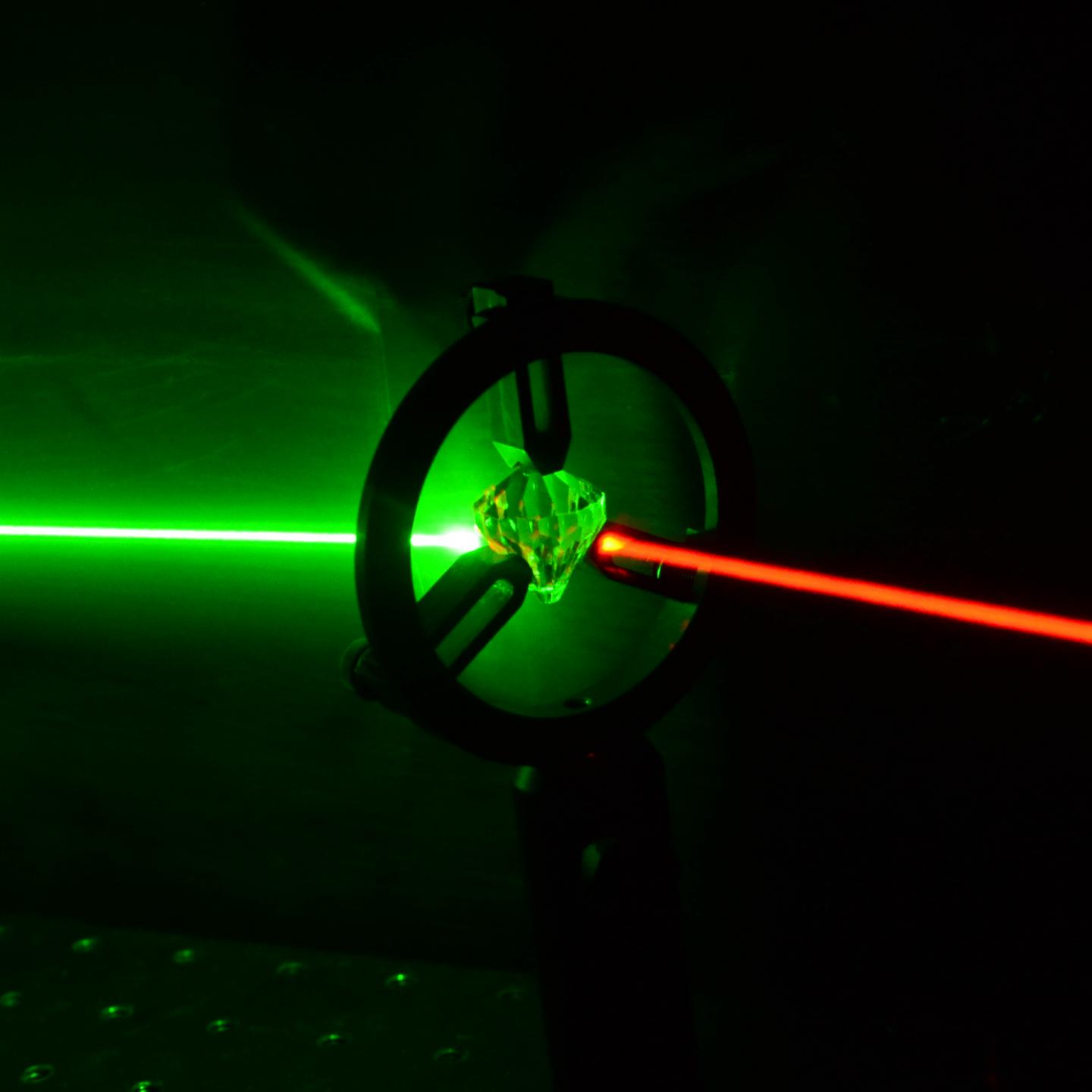 This is an artist's impression of quantum frequency conversion in a diamond quantum memory. Researchers from the Institute for Quantum Computing at the University of Waterloo and the National Research Council of Canada (NRC) have, for the first time, converted the colour and bandwidth of ultrafast single photons using a room-temperature quantum memory in diamond. Credit Dr. Khabat Heshami, National Research Council Canada