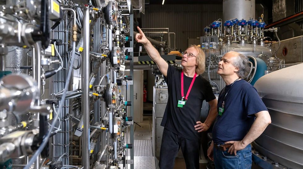 PSI researchers Bernhard Lauss (left) and Geza Zsigmond examined around 25 billion neutrons at PSI’s ultracold neutron source. They have largely ruled out the hypothesis that neutrons spontaneously turn into mirror neutrons. © Paul Scherrer Institute PSI/Markus Fischer