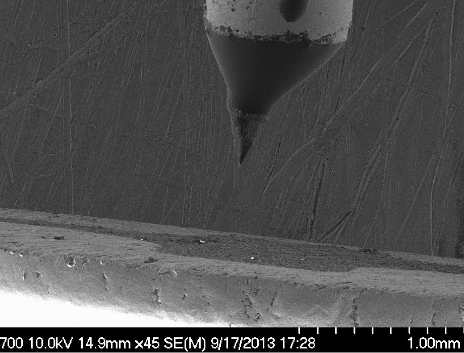 Using a scanning electron microscope, aerospace engineers examine the needle-like tip of a stream of ions in a jet fuel designed for nanosatellites.