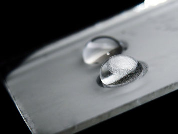 More Than Just Ions: What Causes Droplet Charging?