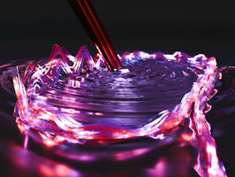 Racetrack-shaped lasers for bright, stable frequency combs
