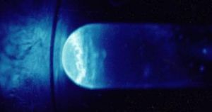 Quartz vial glowing from the intense alpha radiation emitted by 300 micrograms of einsteinium-253. Photo by R. G Haire.