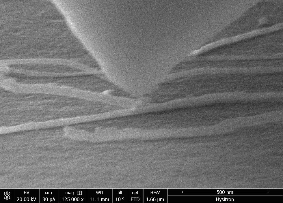 A picoindenter approaches the junction of a branched nanotube in an experiment carried out by Rice University scientists. The researchers discovered these nanotube “letters” handle strain to varying degrees depending on their form. (Credit: Hysitron)