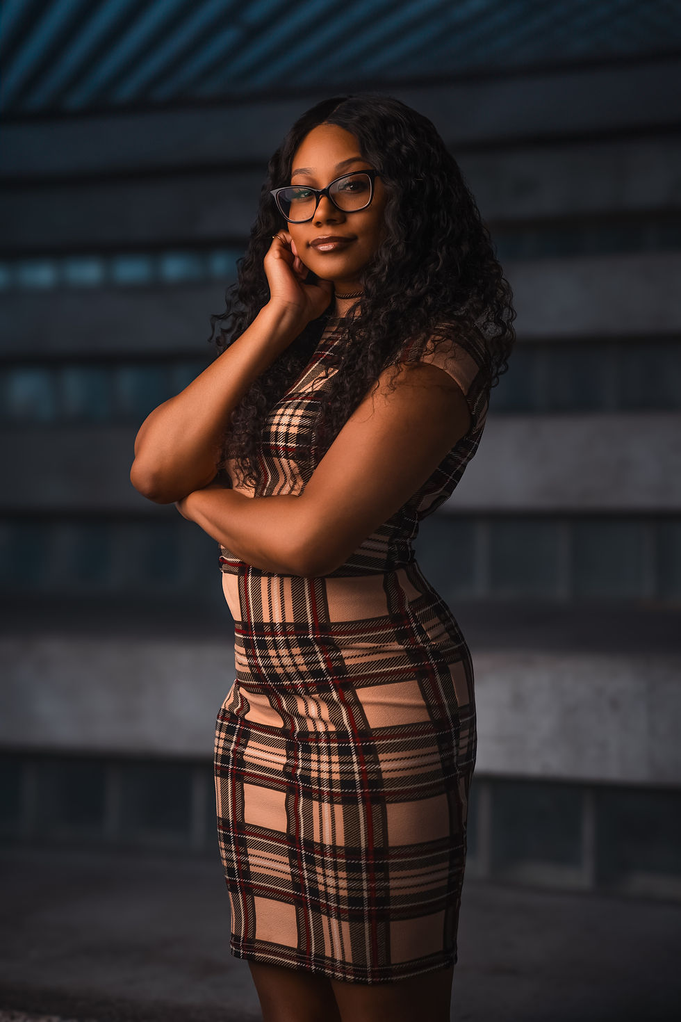 Eye-level view of Renni Mills confidently posing in a vibrant outfit