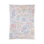 Soft comforter with curled-up cats and pastel floral pattern.