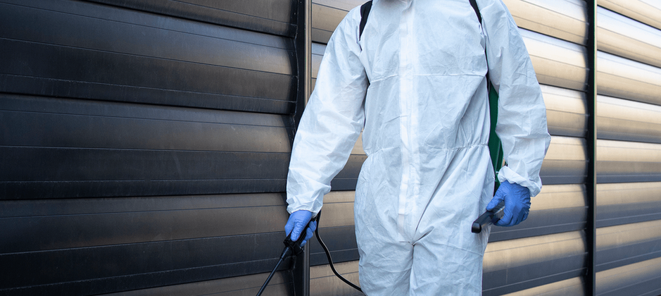 person-in-white-chemical-protection-suit-doing-disinfection-and-pest-control-and-spraying-