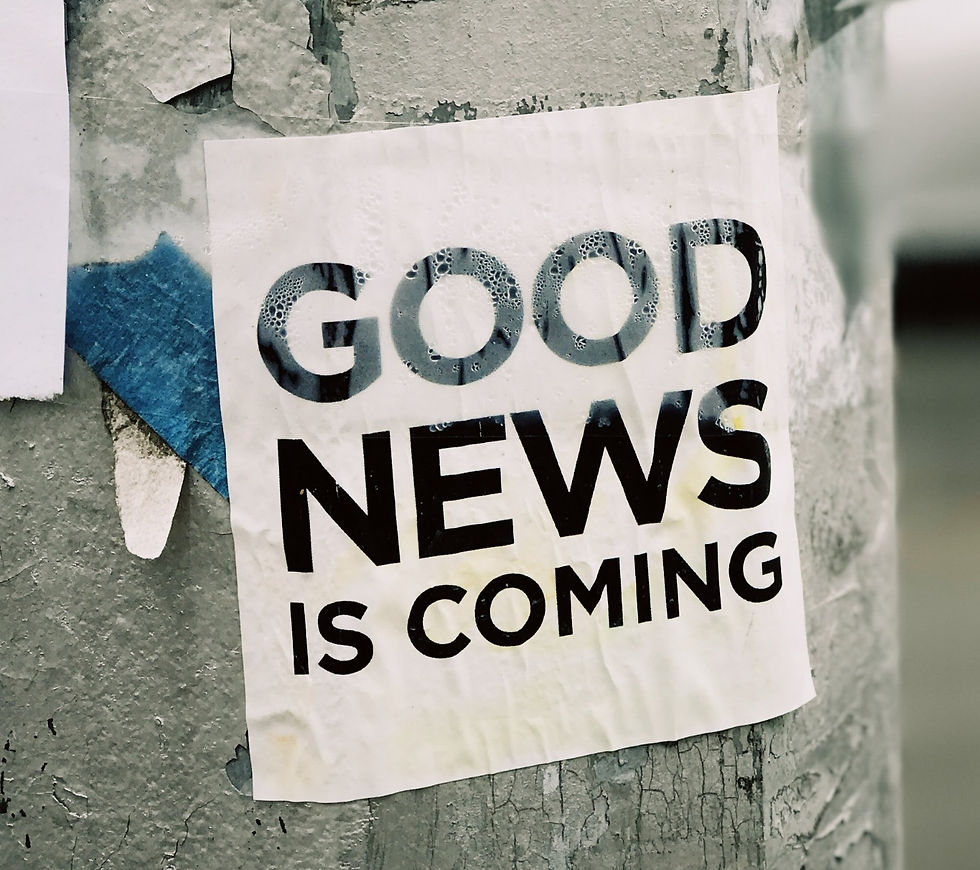 "Good News is coming" sign on a post