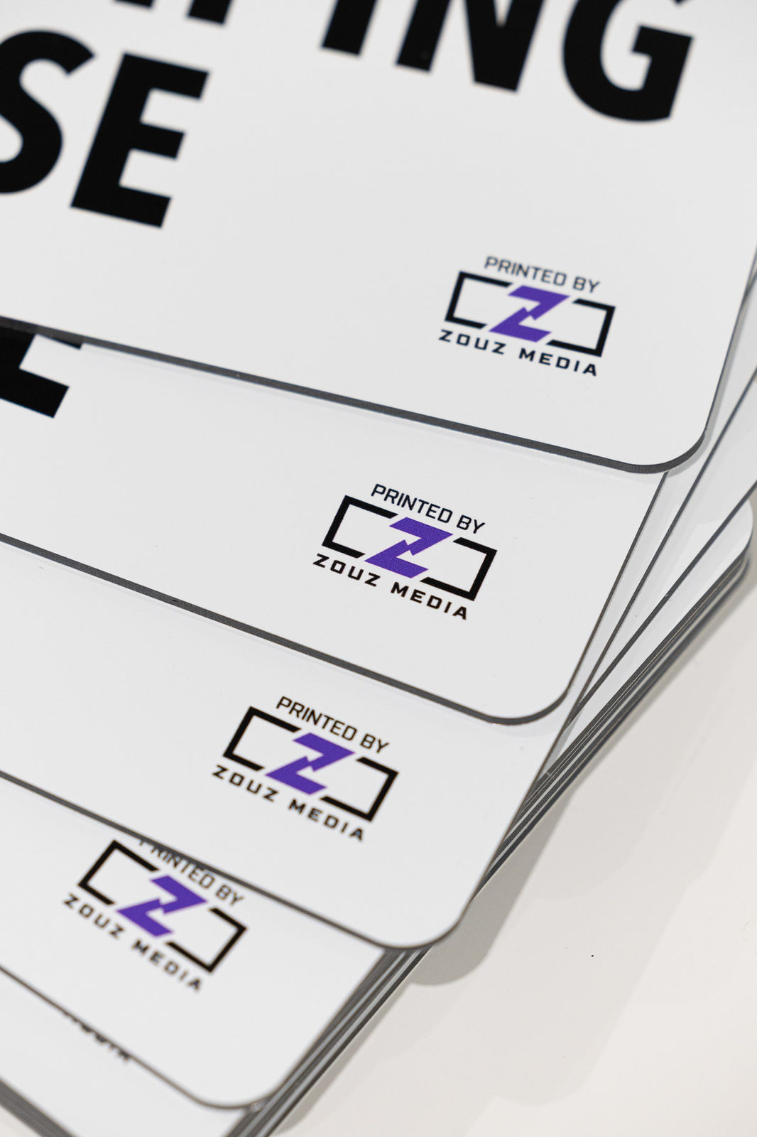 Stack of printed Zouz Media business cards