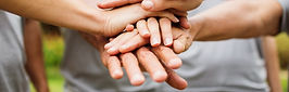 group of people wih hands stacked