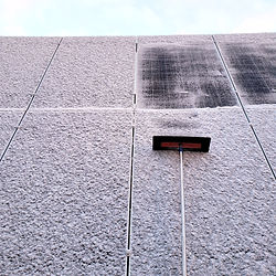 Winter challenges of living off-grid with solar panels. Removing snow and ice from solar panels