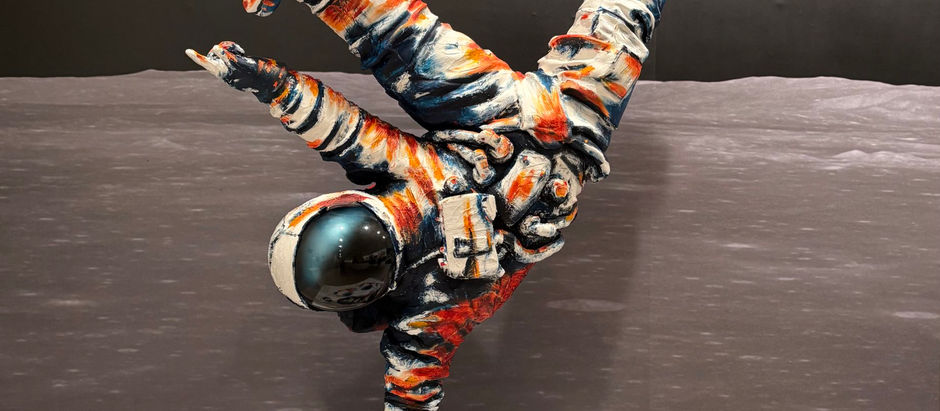 Colorful astronaut sculpture balances one-handed on a moonlike base, with Earth glowing in the dark space backdrop.