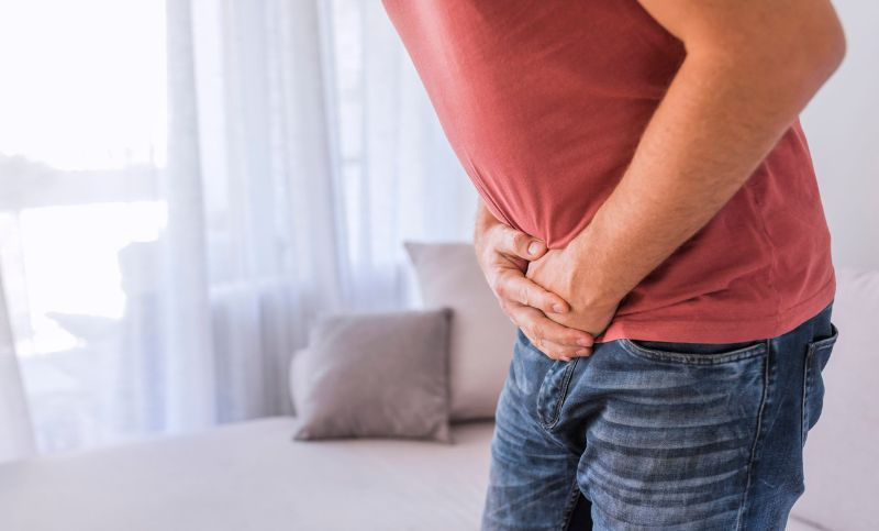 Person holding pelvic area