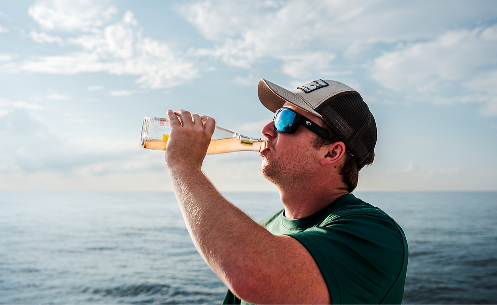 A fisherman drinking a Chesapeake Ranch Water on a boat.
