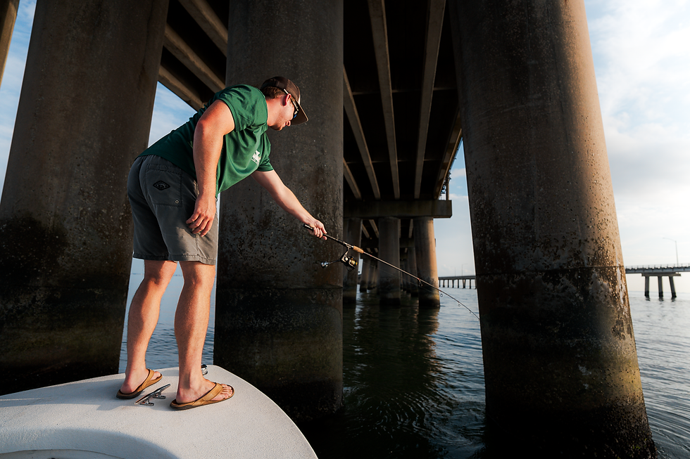 Fisherman sheepshead fishing under a bridge.